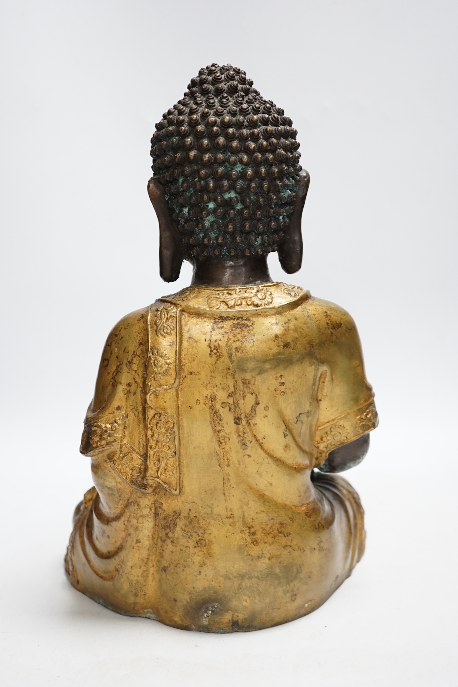 A gilt bronze seated Buddha, 35cm high